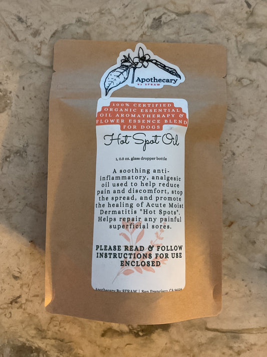 Organic Hot Spot Oil sealed in its Apothecary by SFRAW retail packaging before opening.