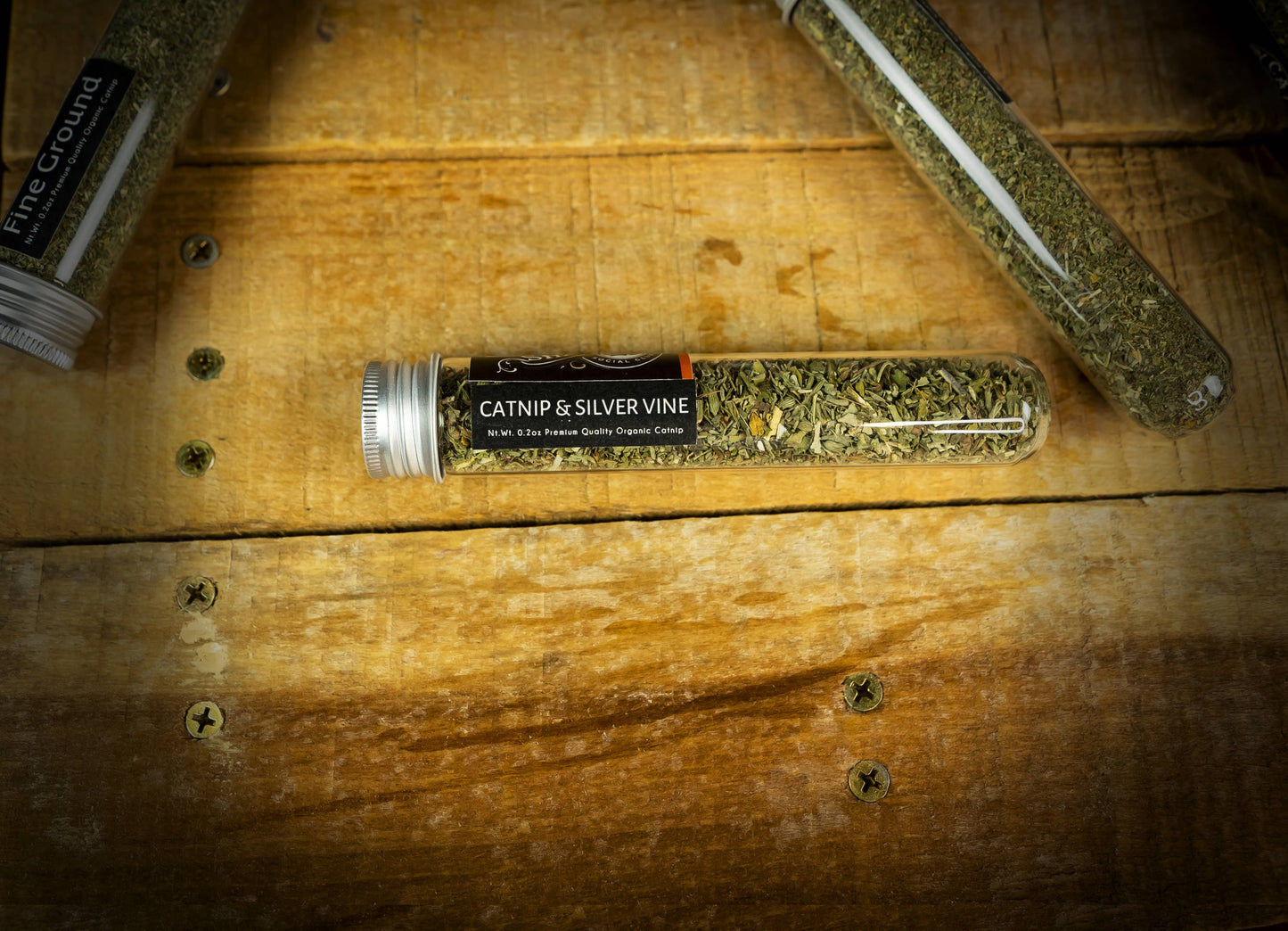 Shady Cat organic catnip and silver vine blend tube displayed on a rustic wooden tabletop