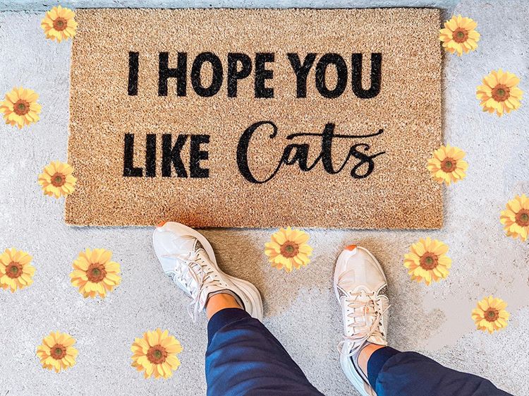 Close-up of I Hope You Like Cats doormat showing natural coir fiber and black lettering