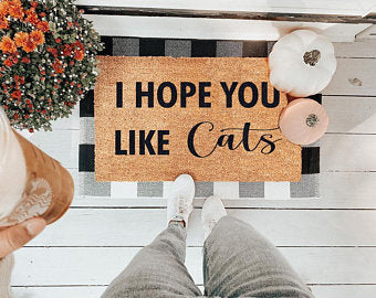 I Hope You Like Cats coir doormat at a front door with a person standing on it